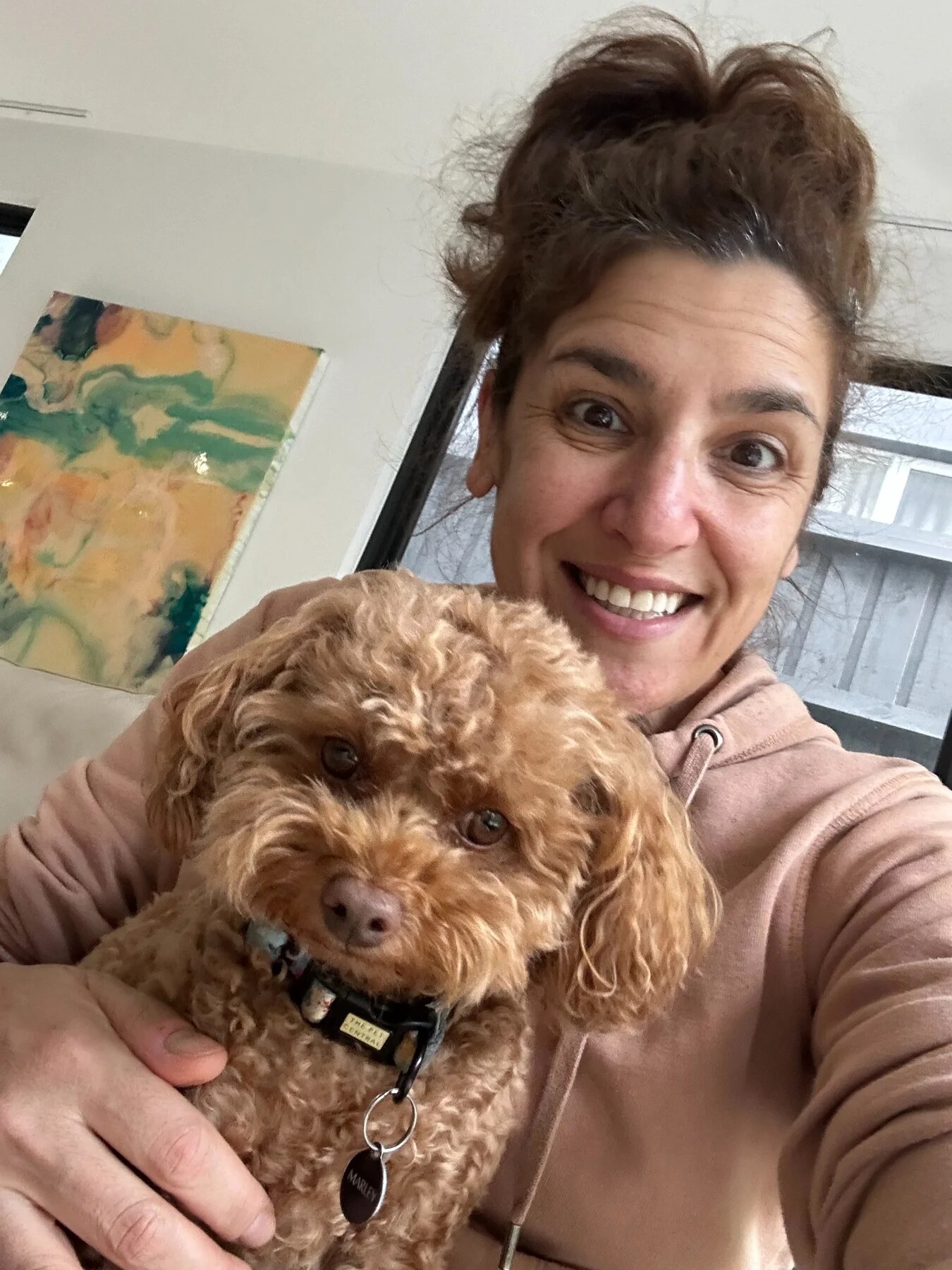 Nicole Goodman cuddling a brown dog she has looked after